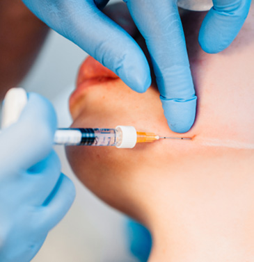 Woman receiving injection near her jaw