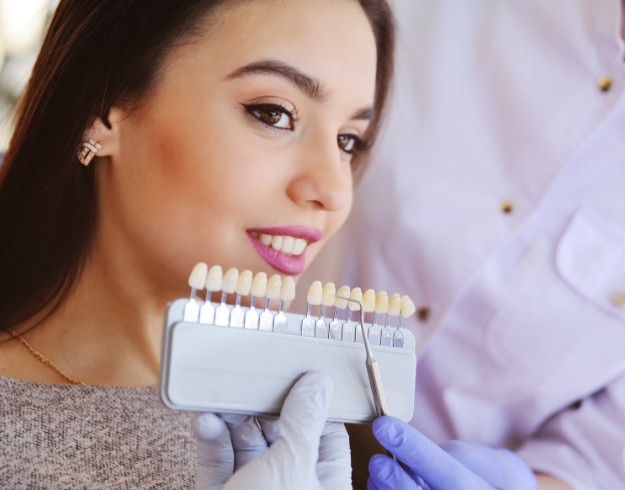 Woman having teeth shade matched for cosmetic dentistry in Orlando