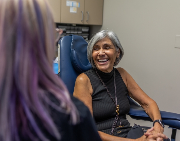 Female dental patient pointing to her smile