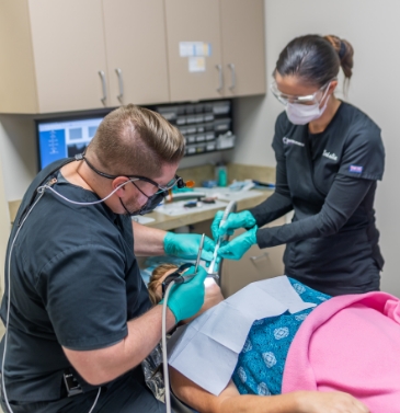 Dentist showing patient image on chairside monitor