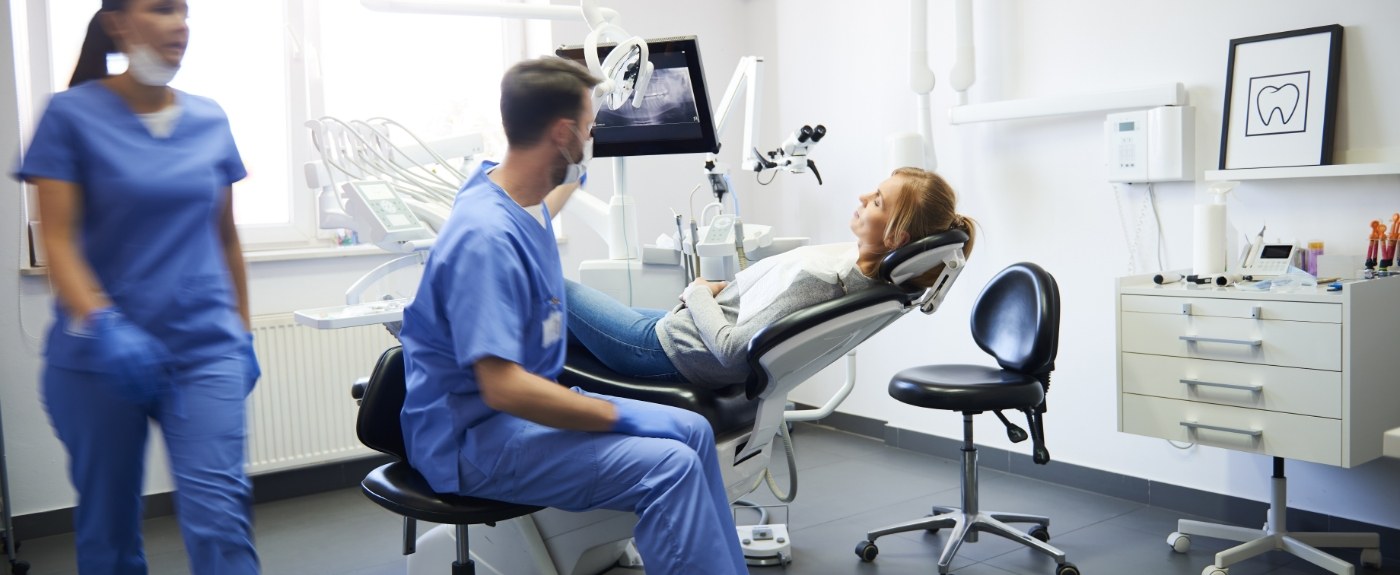 Multiple dentists around a patient