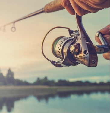 Close up of fishing pole and lake