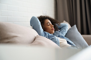 Woman resting on couch at home