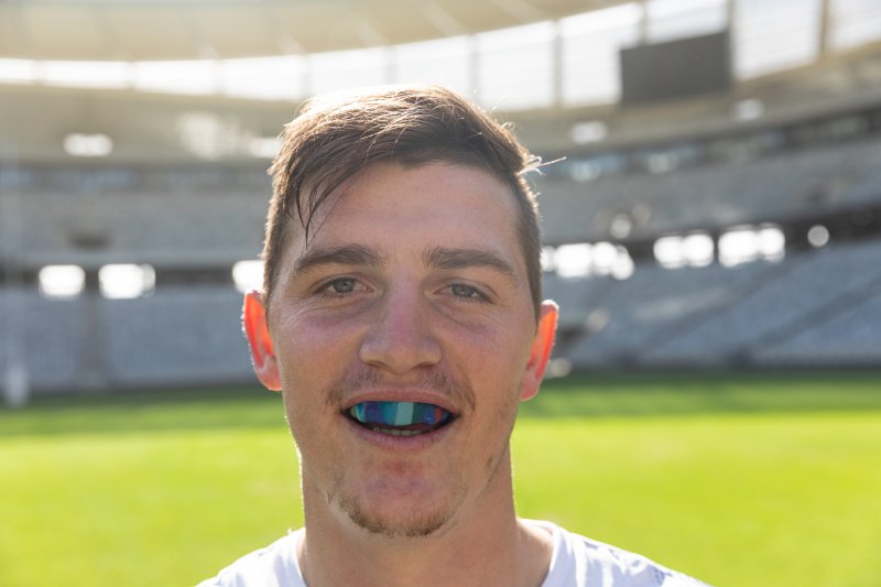 Man wears athletic mouthguard